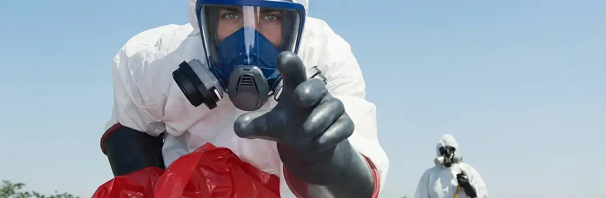sewage clean up technician wearing protective gear handling biohazard materials in Louisville, KY