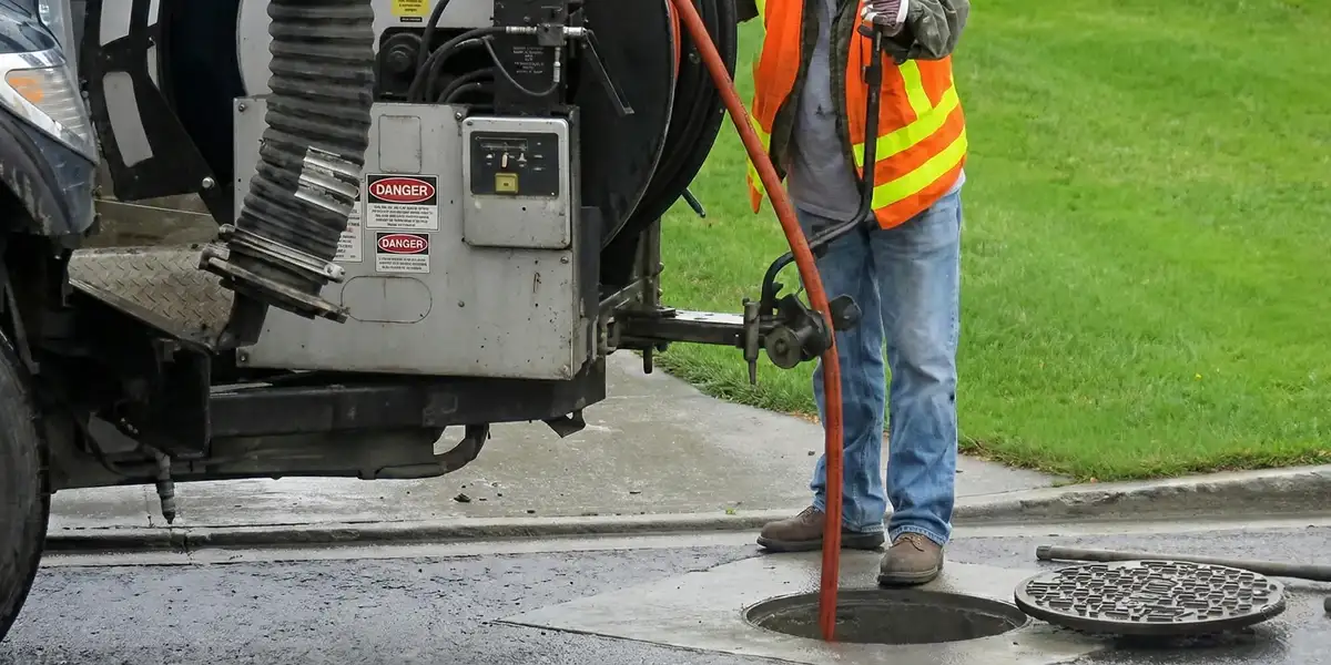 sewage clean up professionals using industrial equipment to remove contaminated wastewater in Louisville, KY