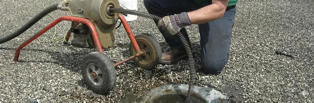 sewer rodding technician actively removing blockages from a sewer line in Louisville, KY