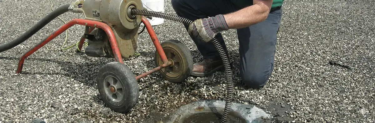 sewer rodding technician actively removing blockages from a sewer line in Louisville, KY