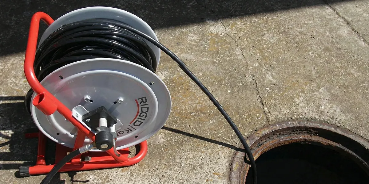 sewer rodding equipment prepared to clear clogged sewer lines in Louisville, KY